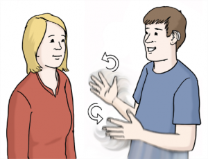 Das Bild zeigt zwei Personen die zueinander blicken. Eine Person macht Gebärden mit den Händen.